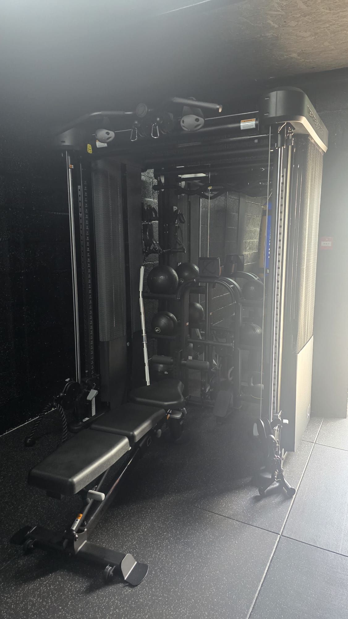 Functional trainer cable machine with an adjustable bench at MPL Box Fit